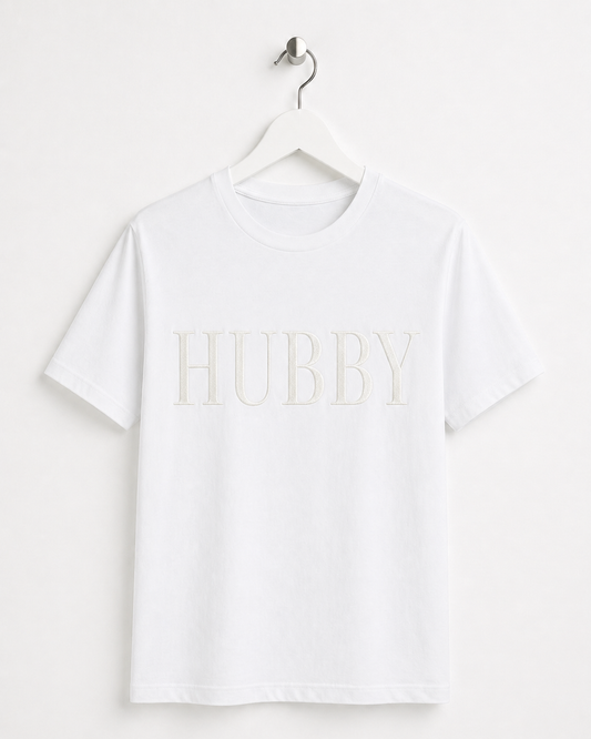 White t-shirt with 'HUBBY' text on a hanger against a white background