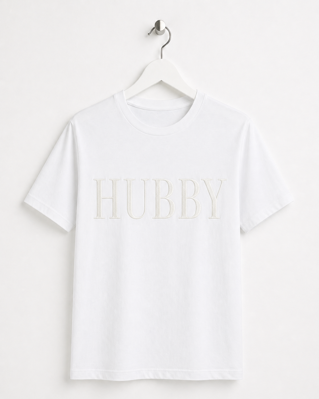 White t-shirt with 'HUBBY' text on a hanger against a white background