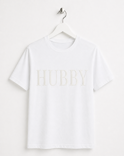 White t-shirt with 'HUBBY' text on a hanger against a white background