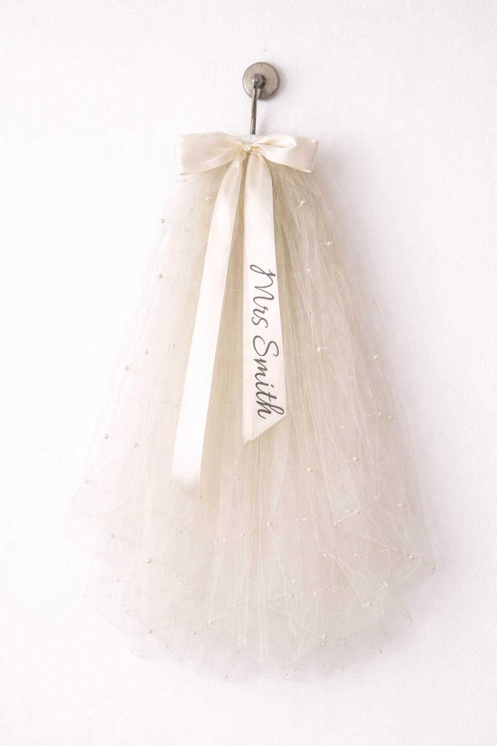 Say "I do" to a personalized veil for your hen do! 🎊 Keep it classy and sophisticated with your own message on the ribbon. With a secure comb grip, you’ll be ready to party all night! 